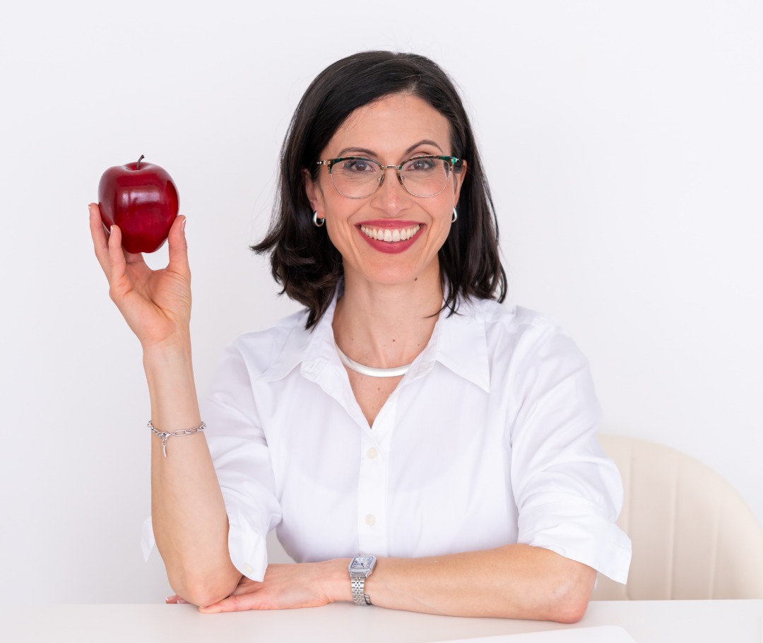 female doctor holding an apple for health 