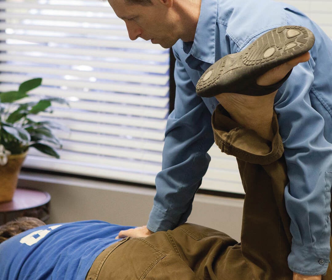 Brandt Adams chiropractor adjusting a client