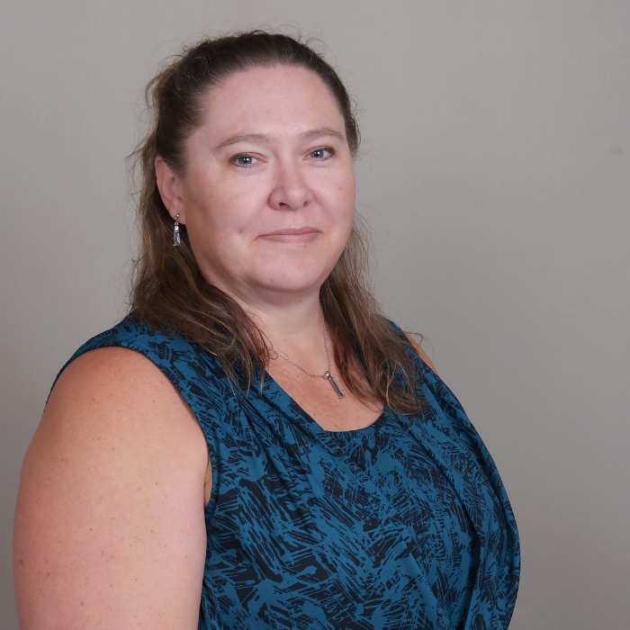 Professional headshot of provider in teal blouse